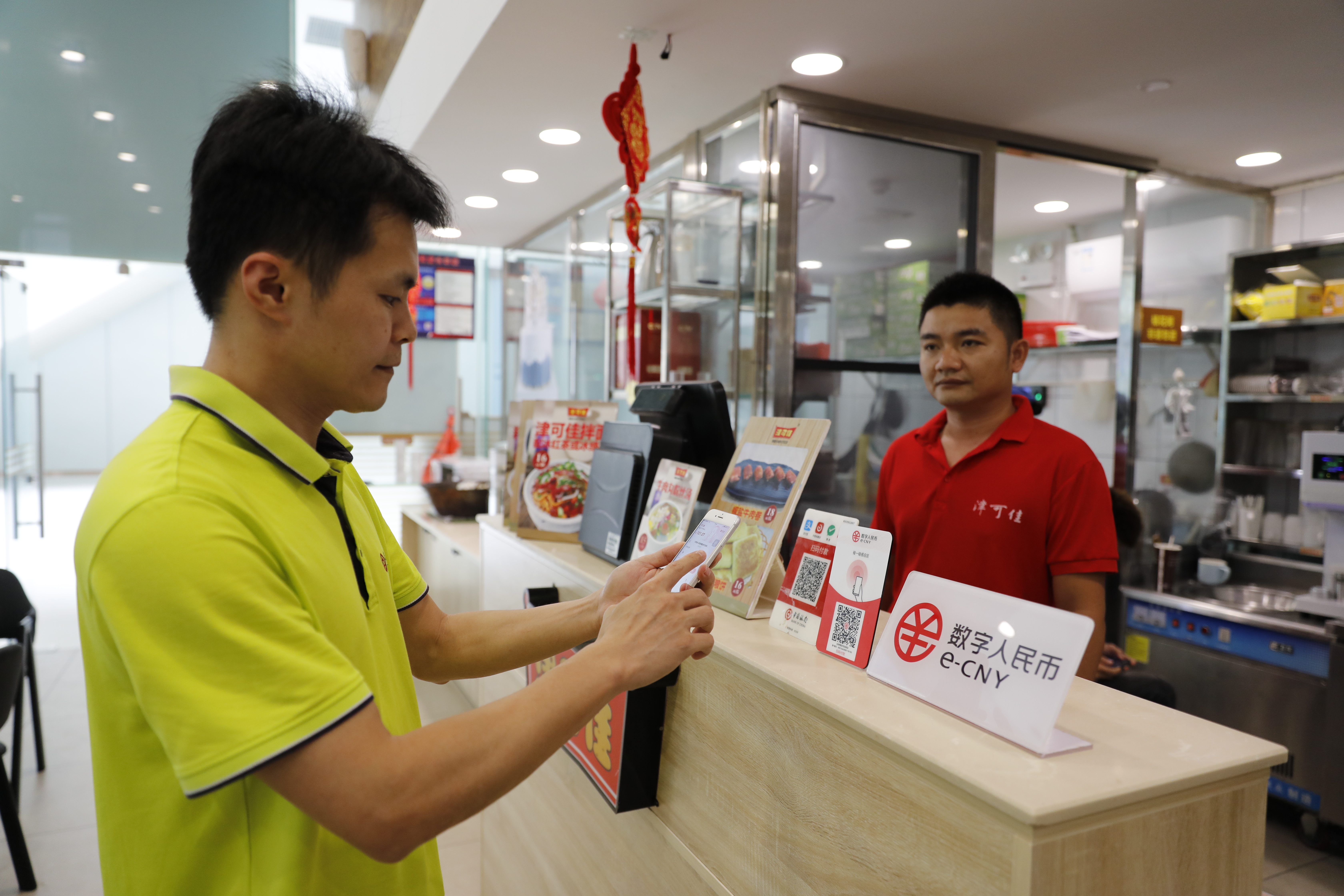 4月18日,博鳌乐城国际医疗旅游先行区内,消费者通过手机终端向商家支付数字人民币。新华社记者吴茂辉摄